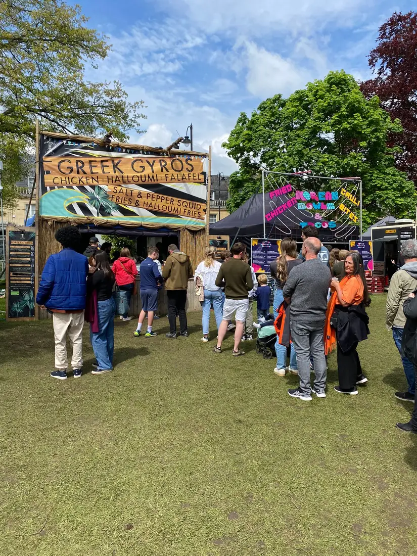 Festival crowds queuing at the Castaway Kitchen Greek gyros unit