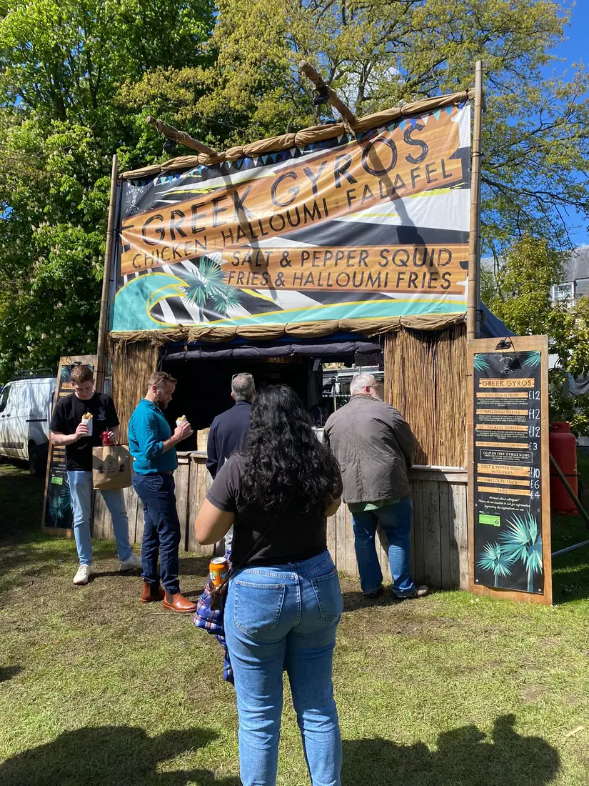 The Greek gyros unit serving a busy queue on a sunny day
